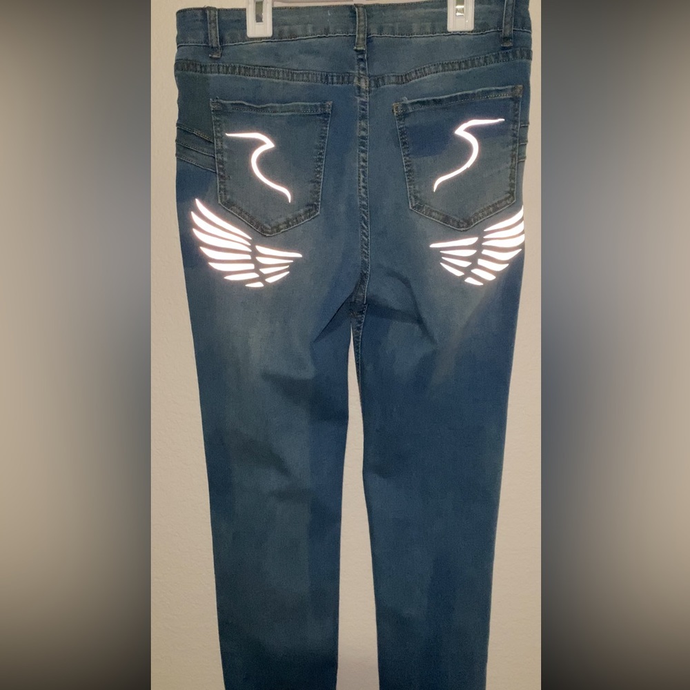 Junior size 13 skinny jeans with reflective design on back and front